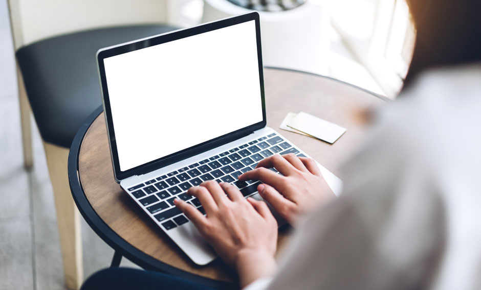 Woman typing on a laptop